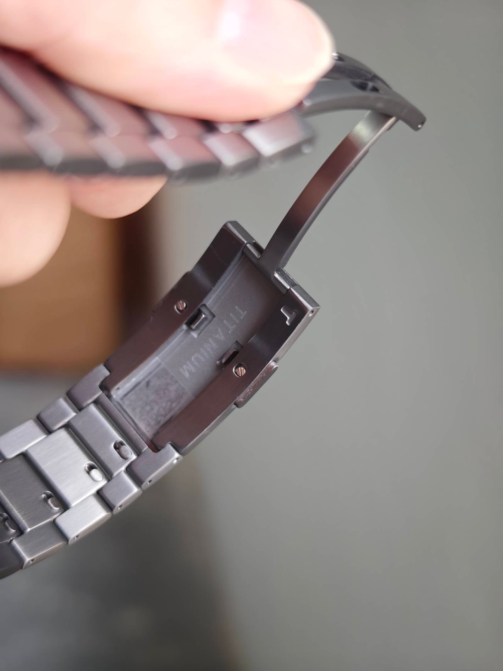 Three-link titanium bracelet detail showing individually removable links