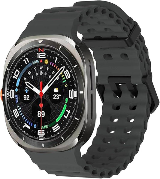 Black silicone sport band worn on Samsung Galaxy Watch Ultra 47mm with white face, breathable perforated design